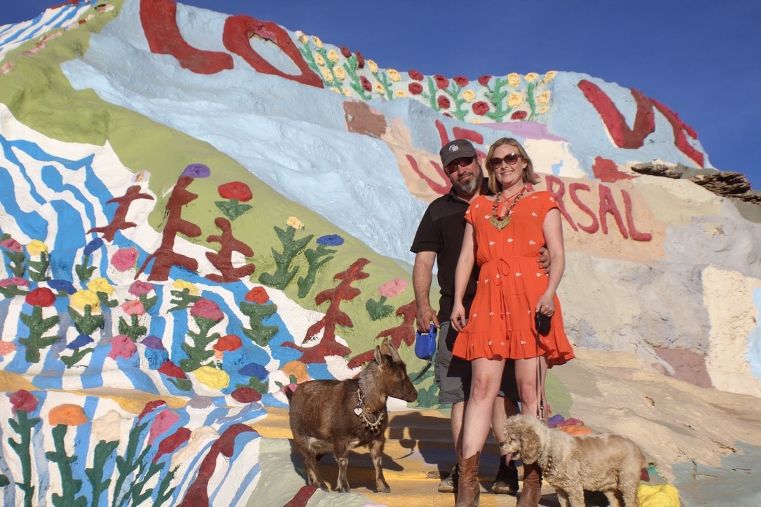 Man and woman with pet goat and dog at Salvation Mountain near Indio