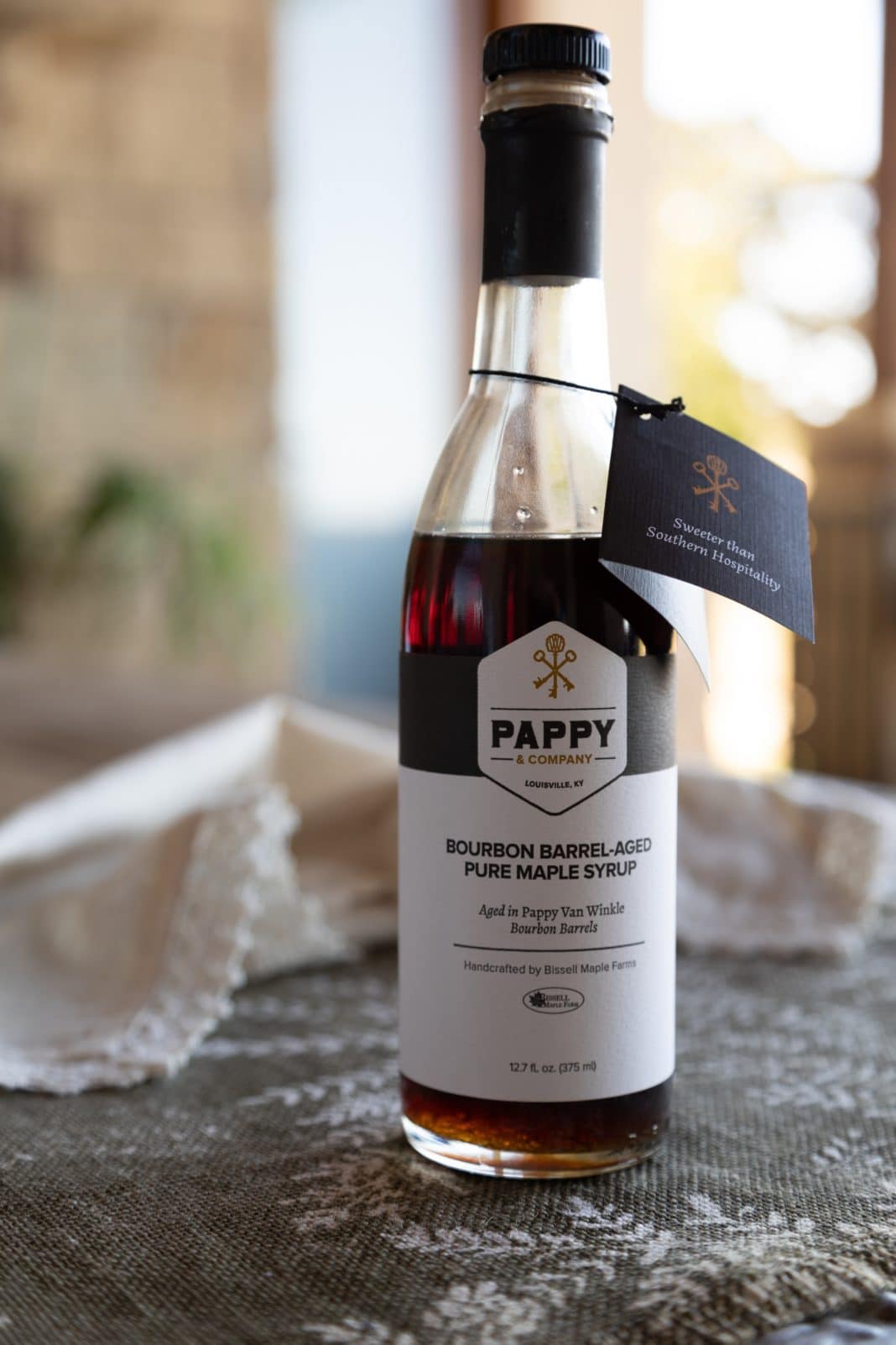 Bottle of Pappy & Company bourbon barrel-aged pure maple syrup on table cloth