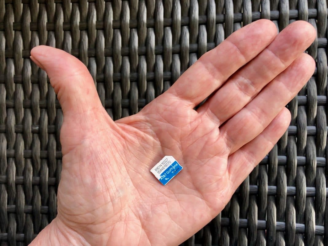 Man's hand with SIM card in palm of hand