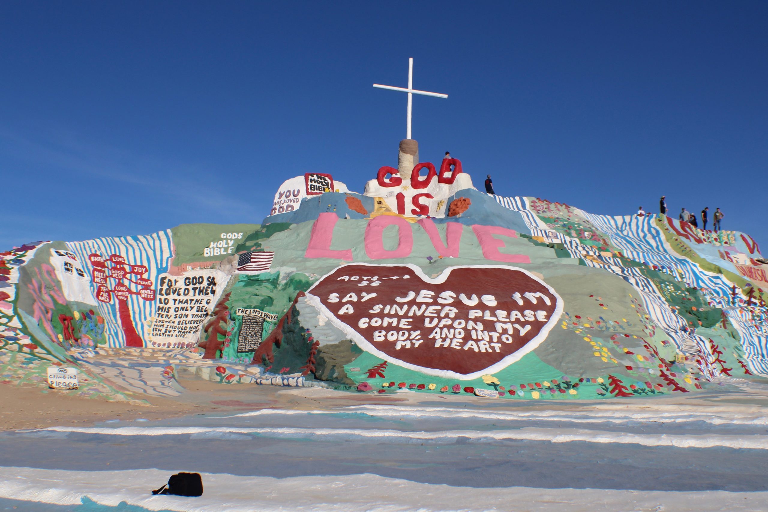 Salvation Mountain displaying biblical messages and cross 