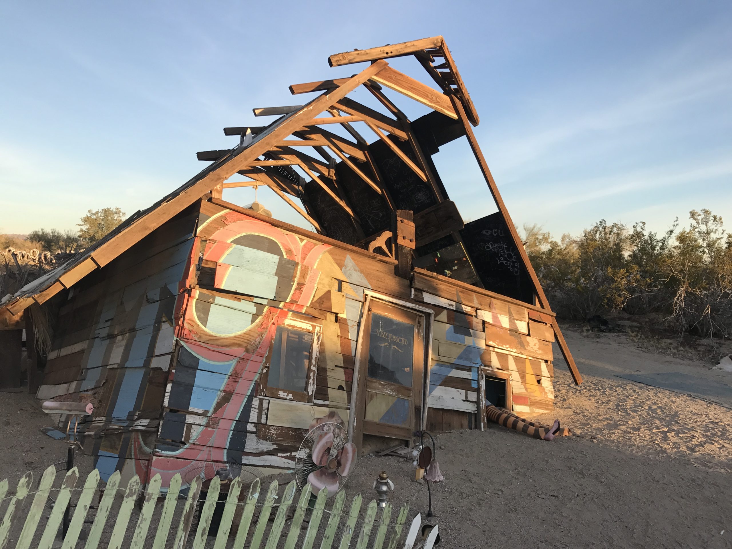 Old wooden art sculpture house depicting Wizard of Oz house and witches legs