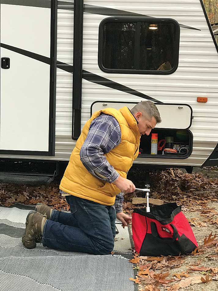 The author inspects his took bag outside their travel trailer