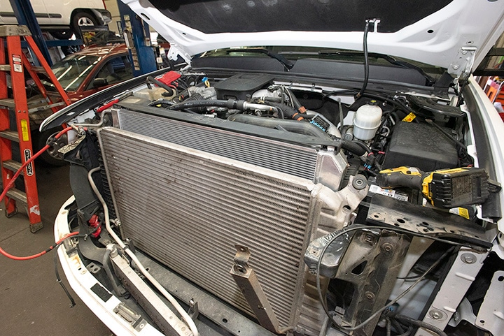 View of engine behind the grille and under the hood