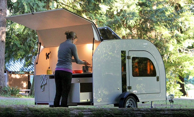 The Droplet trailer's rear kitchen includes a two-burner camp stove and a 12-volt DC fridge.