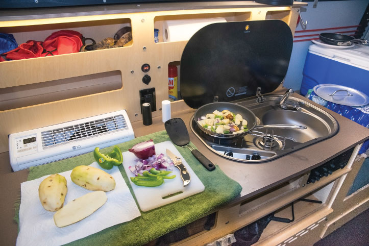 Made from marine-grade birch plywood, the galley houses a two-burner Dometic stove-and-sink combo and offers more than enough counter space for meal prep. 