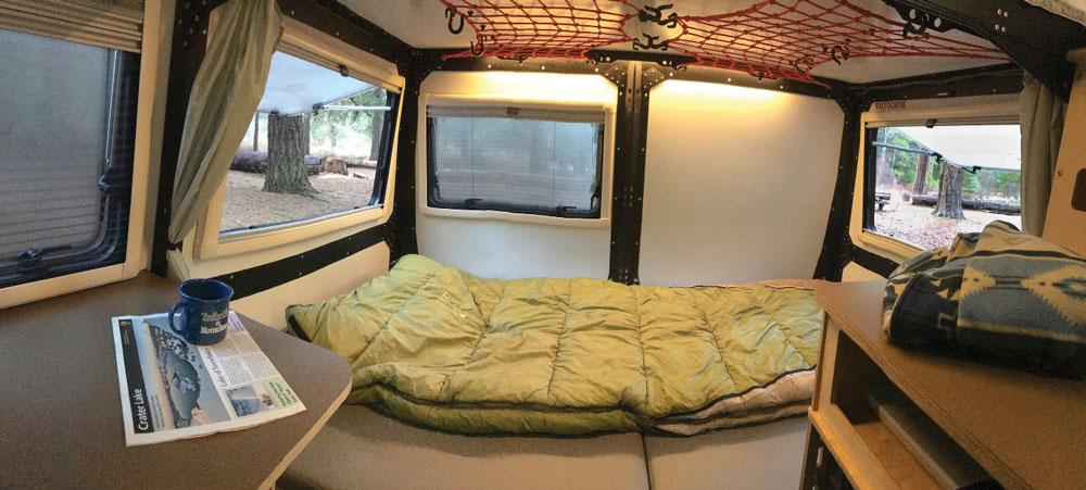 By folding down the split-back bench seat, the rear of the Taxa Mantis Trek becomes a queen-size bed.