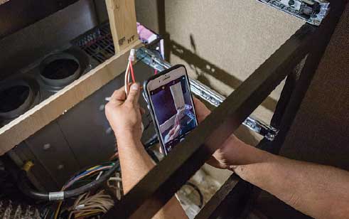 1) Before pulling out the original forced-air furnace to make room for the new Aqua-Hot 250P hydronic heater, a reference photo is taken of the wiring.