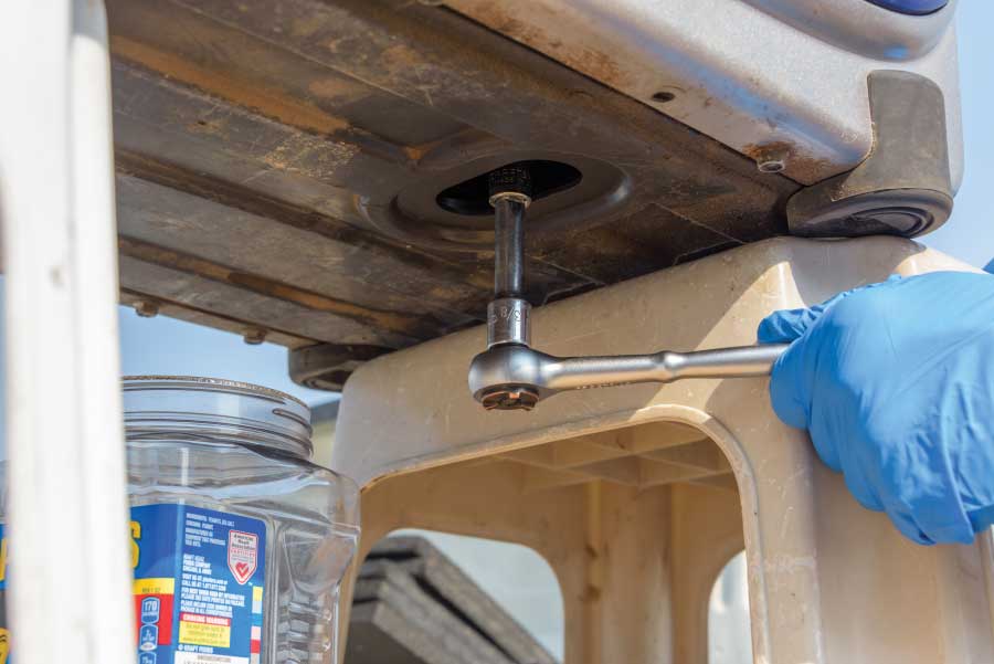 Use a socket and ratchet to remove the drain plug.