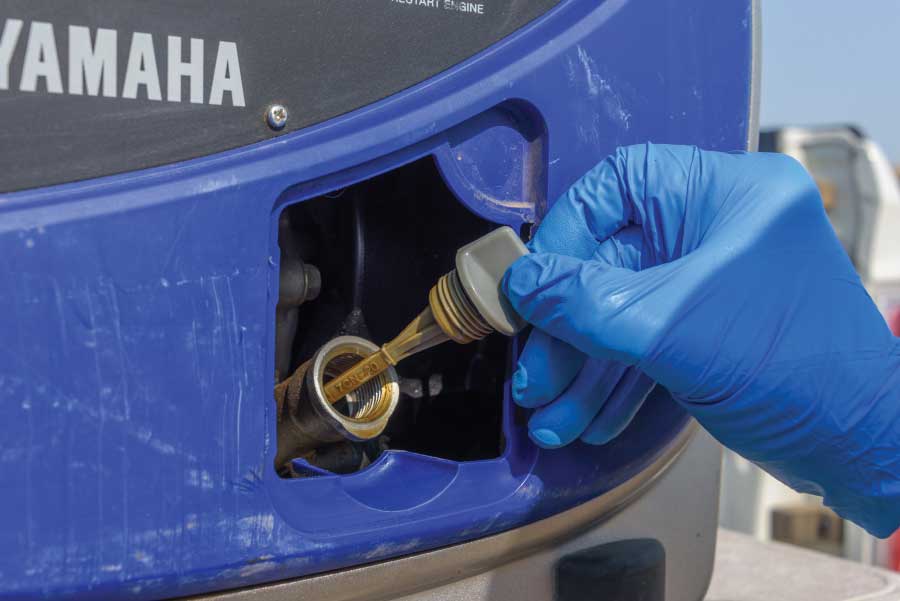 On the front of the generator, remove the dipstick to ease the flow of oil while draining.