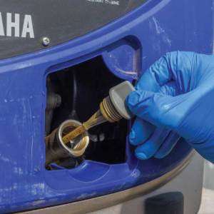 On the front of the generator, remove the dipstick to ease the flow of oil while draining.