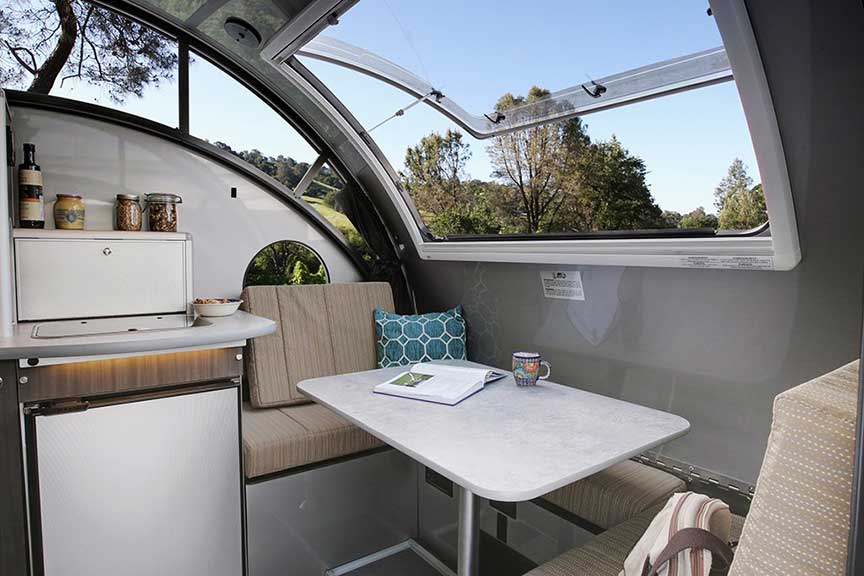 Window open above table in Alto trailer.