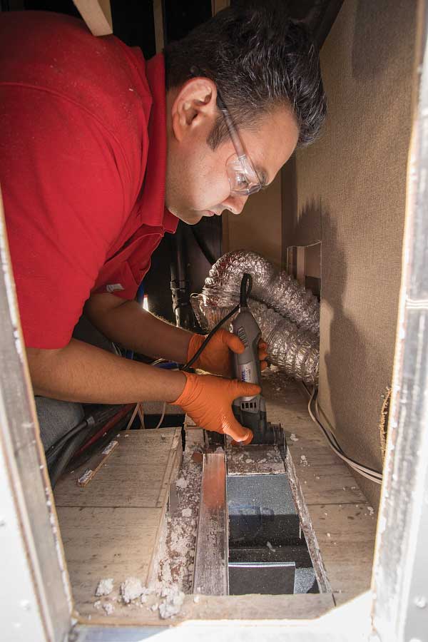 5-9) A hole is cut for the flange, and the new Aqua-Hot 250P unit is set in place, allowing for the exhaust pipe to be connected.
