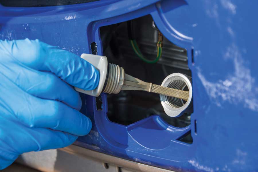 Use the dipstick to check the oil level.