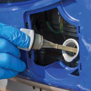 Use the dipstick to check the oil level.