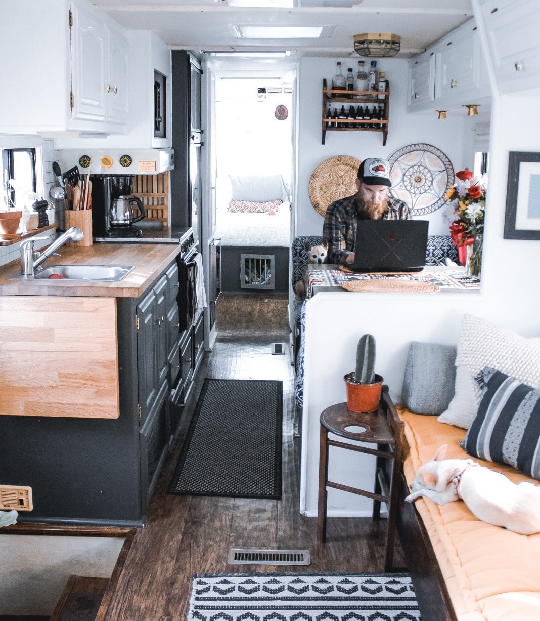 Bearded man working on laptop in nicely decorated RV