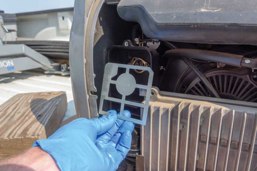 Clean any dust around the edges of the air-filter compartment and wipe down the metal divider that holds the filter. Put the filter and its cover back in place and screw the generator’s side panel back on.