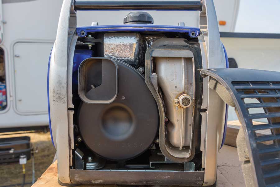 To access the exhaust spark arrester, unscrew and remove the opposite-side panel on the generator.