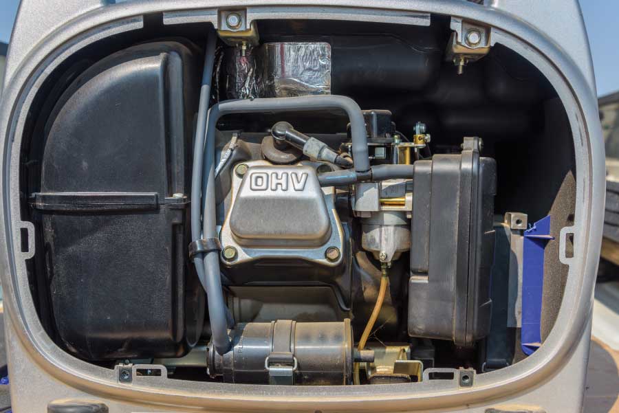 Unscrew and remove the back panel on the generator to access the spark plug.
