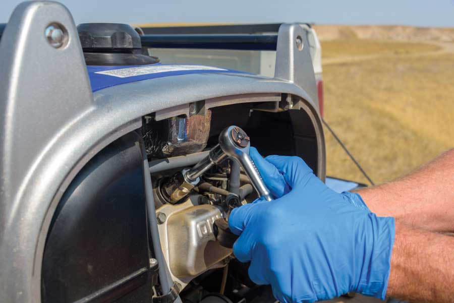 Using a spark-plug socket with a short extension on a ratchet, remove the spark plug.