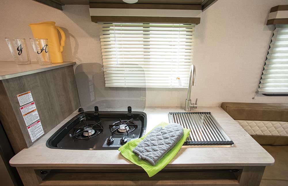 No-Boundaries travel trailer galley with two-burner stove