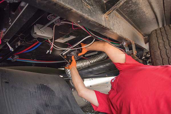 17-19) A Whisper heat exchanger is installed beneath the kitchen-sink cabinet.