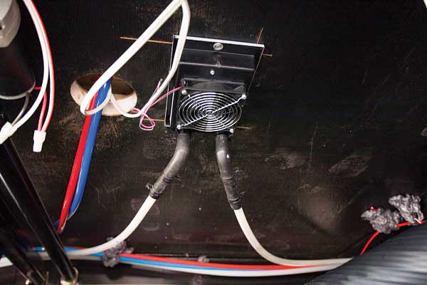 17-19) A Whisper heat exchanger is installed beneath the kitchen-sink cabinet.