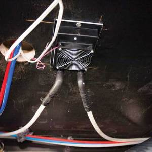 17-19) A Whisper heat exchanger is installed beneath the kitchen-sink cabinet.