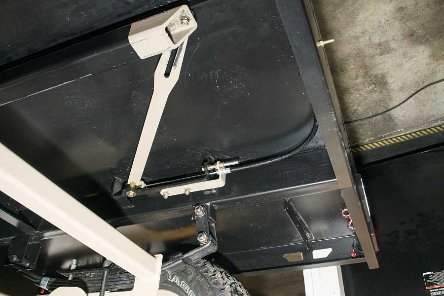 Photo shows the part of the mechanism that locks the axle from steering when the tote is used as a trailer.