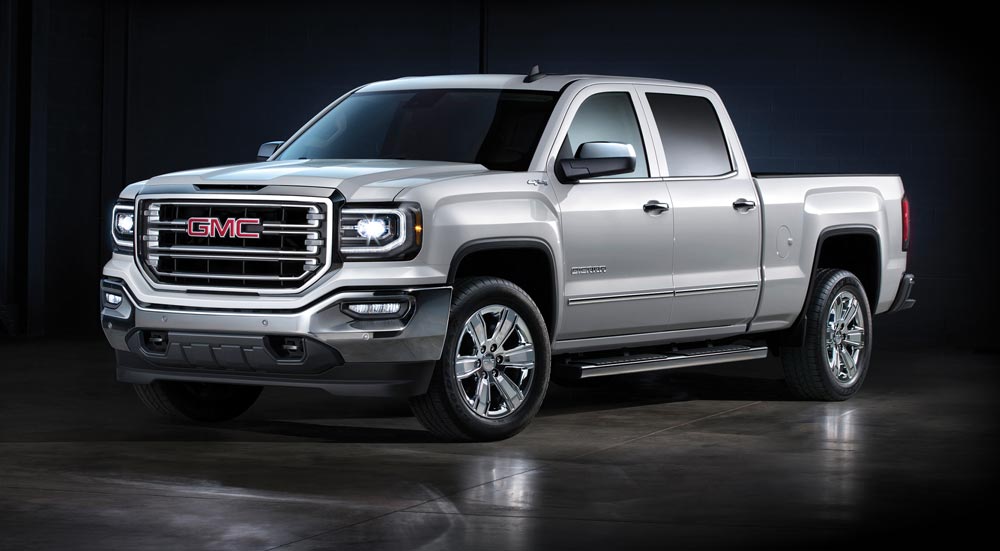 Silver GMC shiny truck with tinted windows