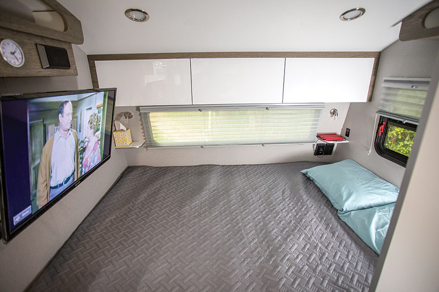 Bed with TV at end in inTech Sol Horizon trailer