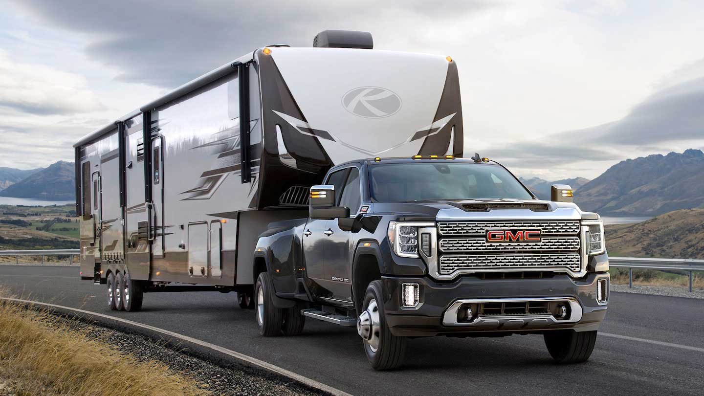 Dark colored heavy duty pickup towing a Keystone fifth-wheel trailer