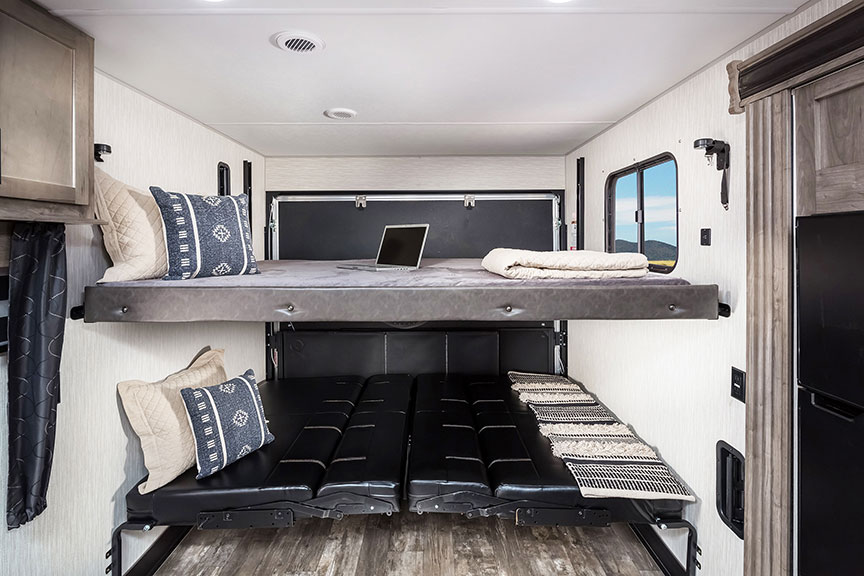 Rear garage of toy hauler with lower and upper beds in position.