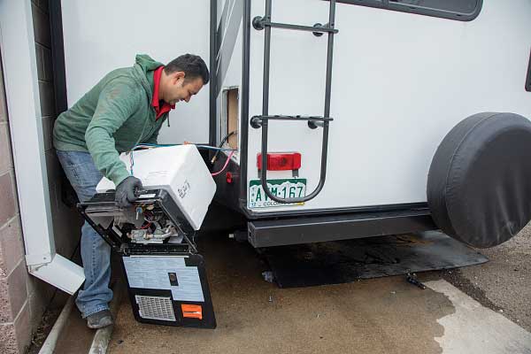 25) The original water heater is removed from the back of the trailer.