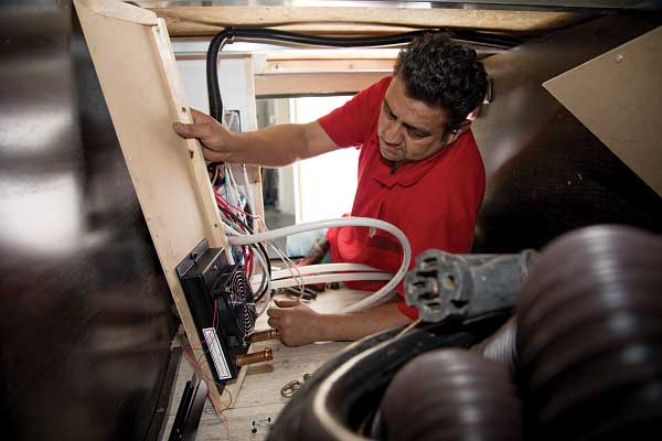 27-28) The Whisper unit installed in the front storage compartment will heat the utilities.