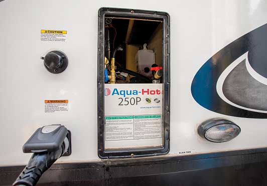 35) Viewed from outside the trailer, the Aqua-Hot unit now occupies the space where the original furnace was located.