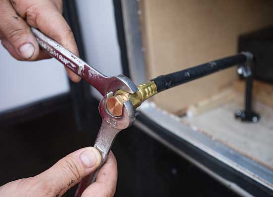 36) A fitting closes off the propane lead to the old water heater, which is also disconnected underneath the RV, as required by NFPA 1192.
