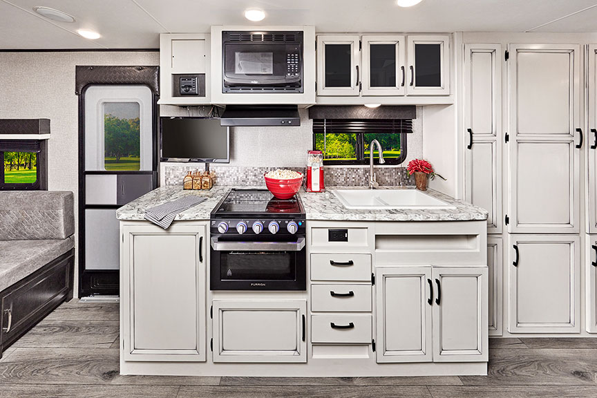 Kitchen of Jayco Jay Feather X23B with whitewashed cabinetry