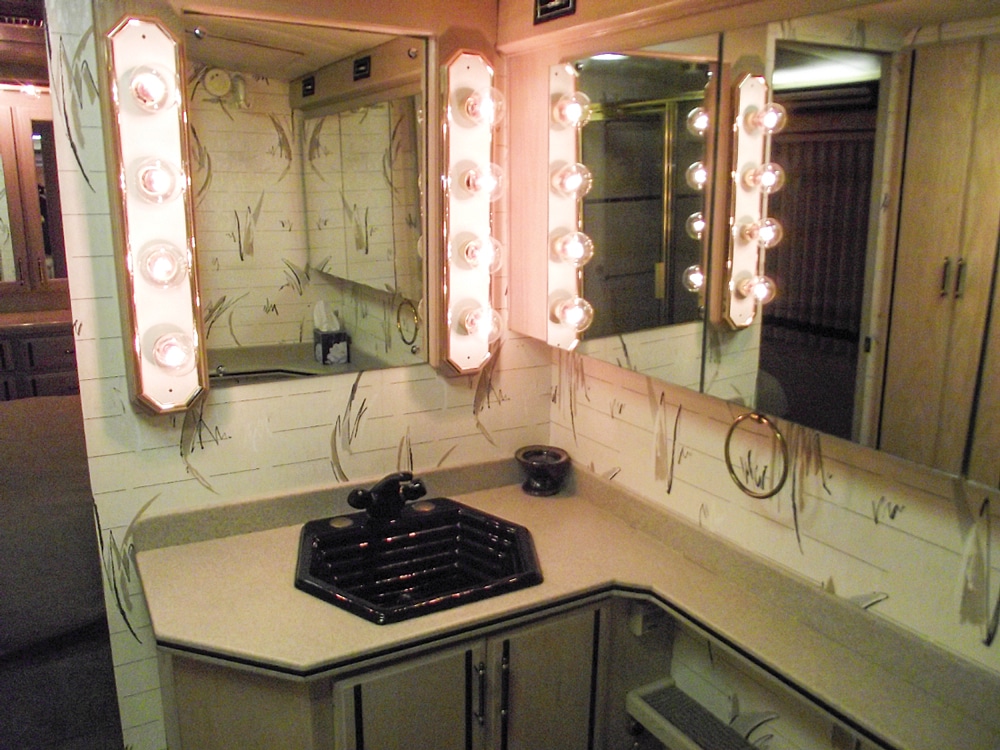 Smartly placed mirrors in the bathroom make the already ample space feel even larger.