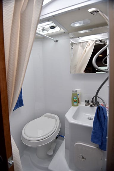 white wet bathroom with sink and toilet