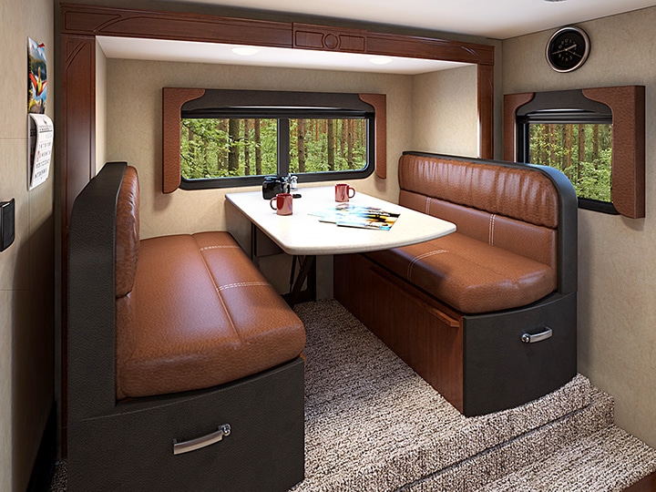 RV dinette in slide-out with brown upholstery.
