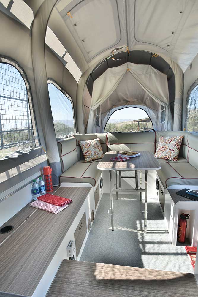 Expansive windows bring the outdoors in. The front bed is behind the six-seat dinette, while the back bed is a step up to the left of the entry door. 