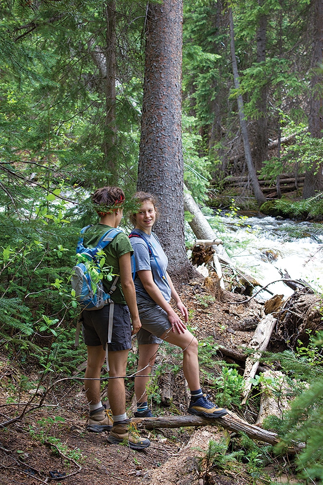 Sophia Clark and Nicole Robertson pause by Difficult Creek during a hike in the Collegiate Peaks Wilderness near Difficult Campground.