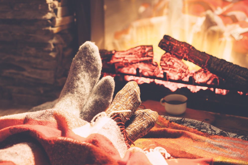 Feet in socks by the fire