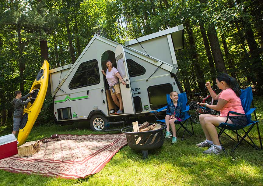 Aliner Expedition trailer with family at campsite