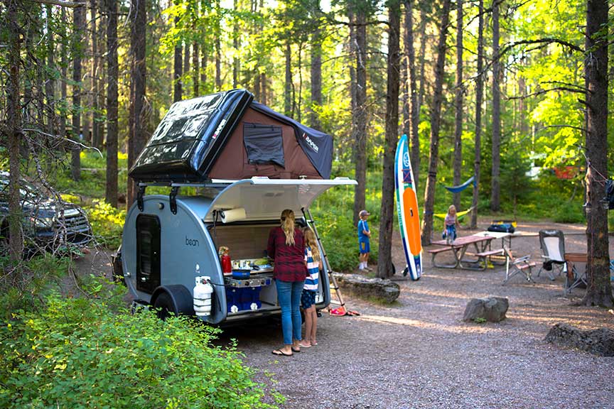 Blue Mean Bean trailer at forest campsite