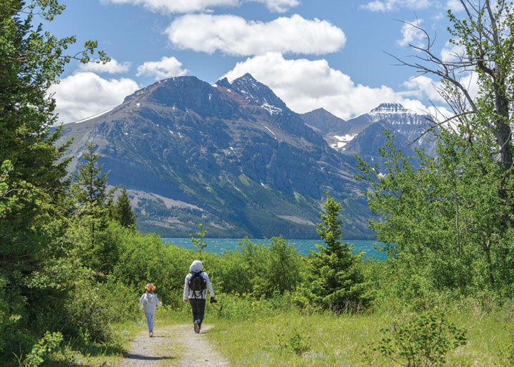 Two hikers on Beaver Pond Loop Trail at Lake Mary in Waterton Lakes National Park