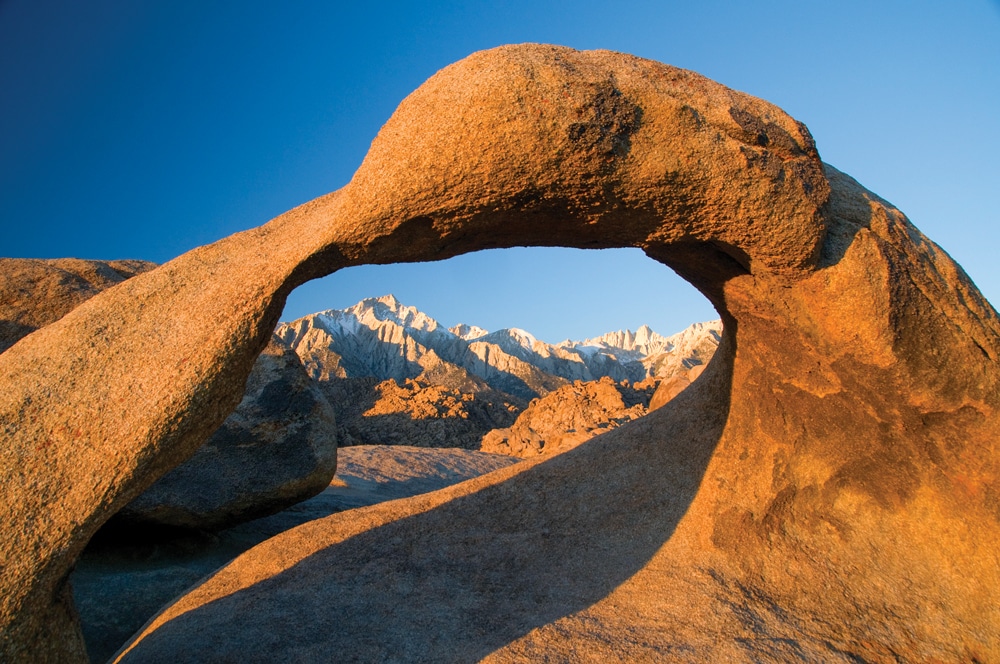 Mobius Arch, accessed by a moderate hiking trail in Alabama Hills Recreation Area, offers the perfect frame for the mesmerizing sight of Mount Whitney.