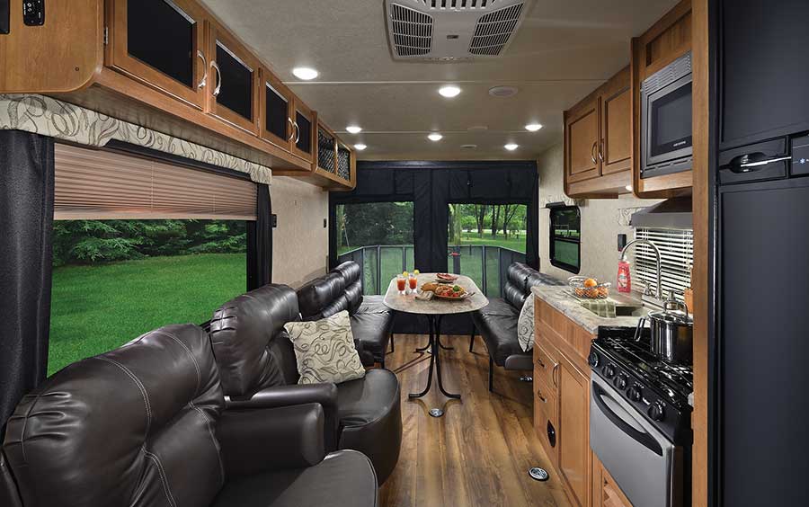 In minutes, the 26TH’s rear dining area with a removable table turns into wall-to-wall sleeping space or a completely open garage with 12 tie-downs. The rear screen wall is standard.