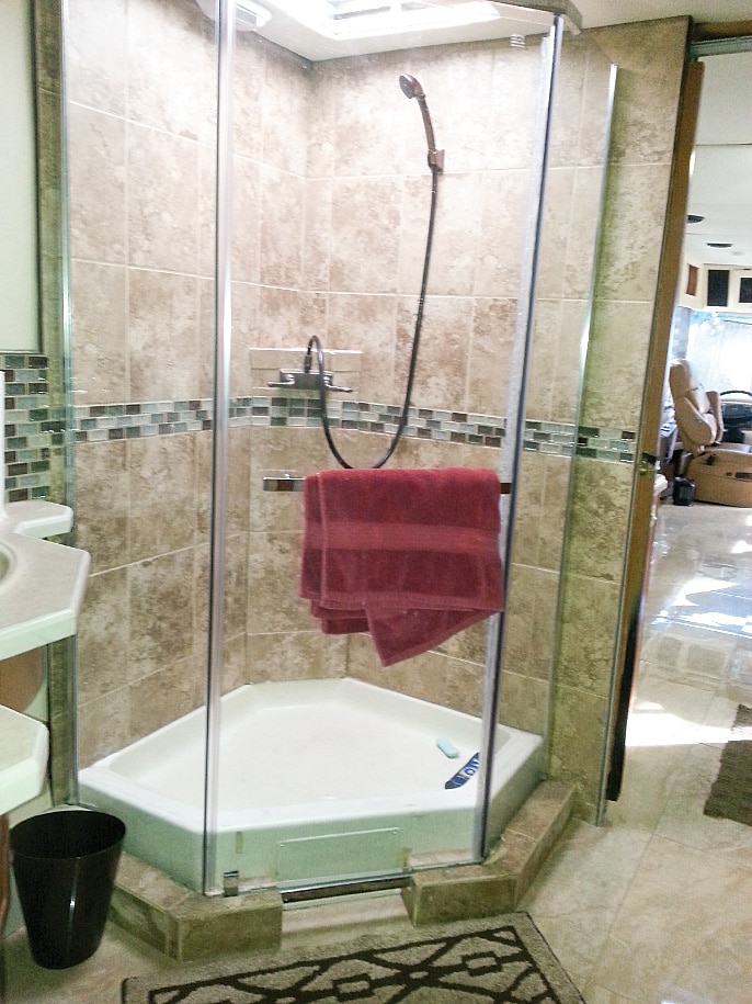 New tile and a tempered-glass shower door helped revive the bathroom.