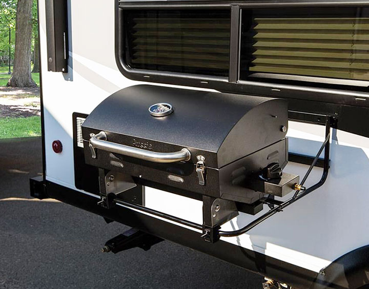 Black grill attached to side of RV